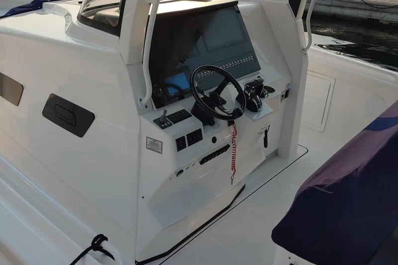 Slide: The Image of 2021 Edgewater 370CC boat cockpit with steering wheel and control panel. - 3