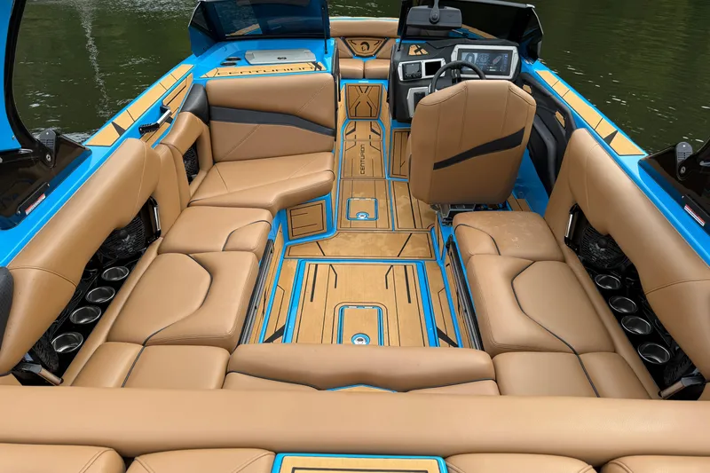 Slide: The Image of Luxurious interior of 2025 Centurion Nv233 boat with tan seating and modern dashboard. - 13