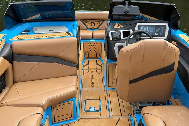 Slide: The Image of Interior of 2025 Centurion Nv233 boat with tan seating and modern dashboard. - 14