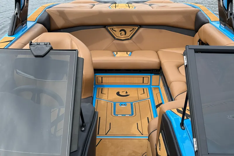 Slide: The Image of Luxurious interior of 2025 Centurion Nv233 boat with tan seating and blue accents. - 18