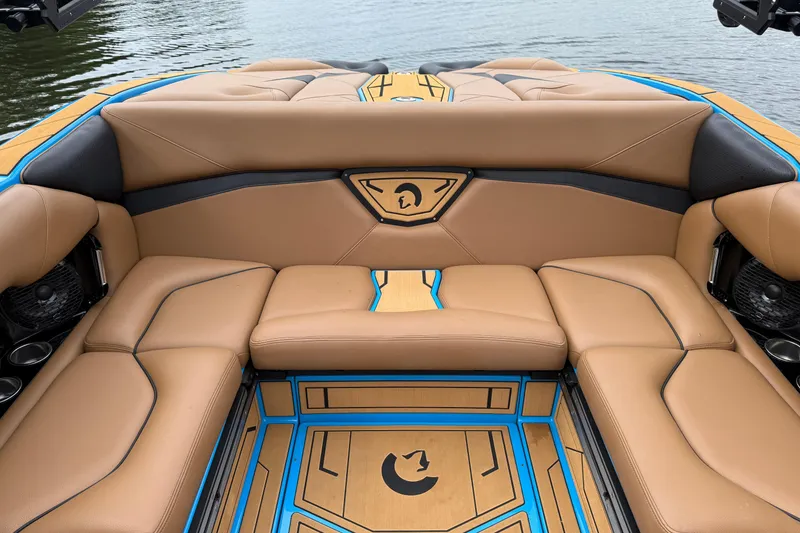 Slide: The Image of Luxurious interior of 2025 Centurion Nv233 boat with tan and blue seating. - 19