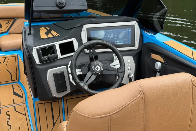 Slide: The Image of Interior of 2025 Centurion Nv233 boat with modern dashboard and steering wheel. - 8