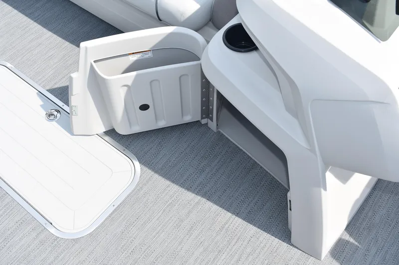 Slide: The Image of 2026 Godfrey Sweetwater SW 2286 C boat interior storage compartment and cup holder. - 15