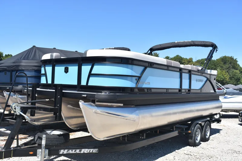 Slide: The Image of 2026 Godfrey Sweetwater 2286C Tritoon boat on trailer, blue and black design. - 4