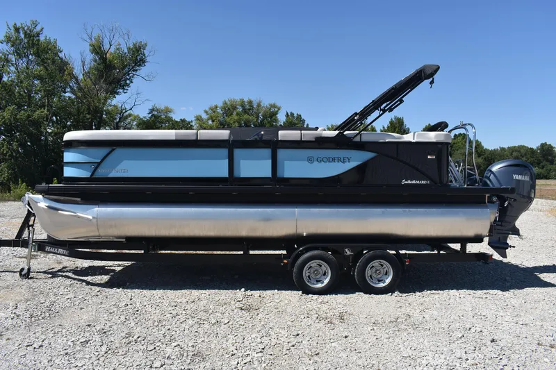 Slide: The Image of 2026 Godfrey Sweetwater 2286C Tritoon on trailer, parked outdoors under clear blue sky. - 5