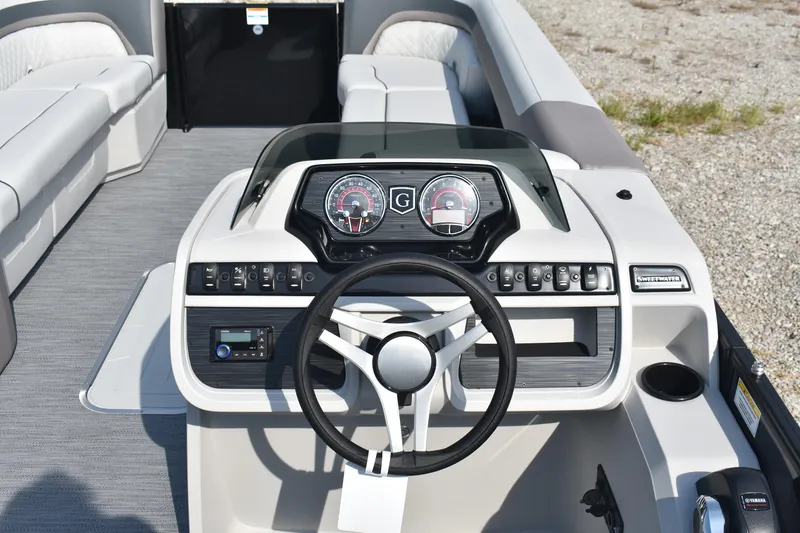 Slide: The Image of 2026 Godfrey Sweetwater SW 2286 C boat dashboard with steering wheel and control panel. - 7