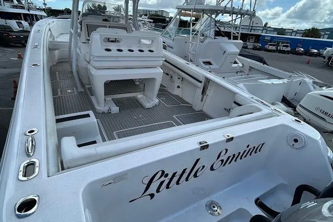Slide: The Image of 2017 Intrepid boat named "Little Emina" docked, featuring spacious deck and seating area. - 4