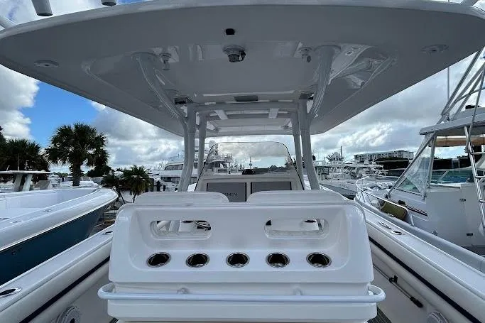 Slide: The Image of 2017 Intrepid boat with rod holders, docked at marina under cloudy sky. - 6