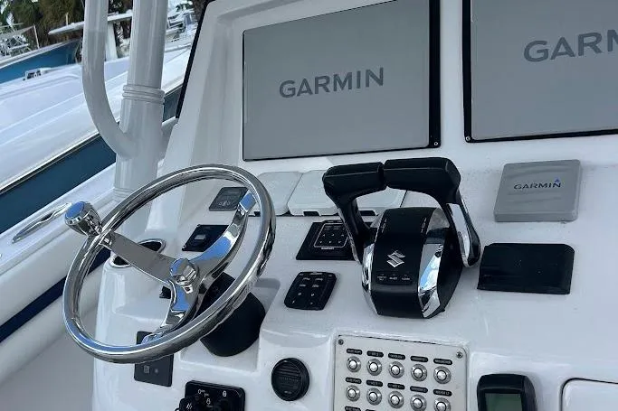 Slide: The Image of 2017 Intrepid boat dashboard with Garmin navigation and Suzuki controls. - 8