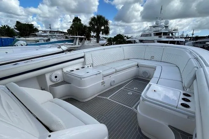 Slide: The Image of Luxurious 2017 Intrepid boat with spacious white seating and sleek design, docked under cloudy skies. - 9