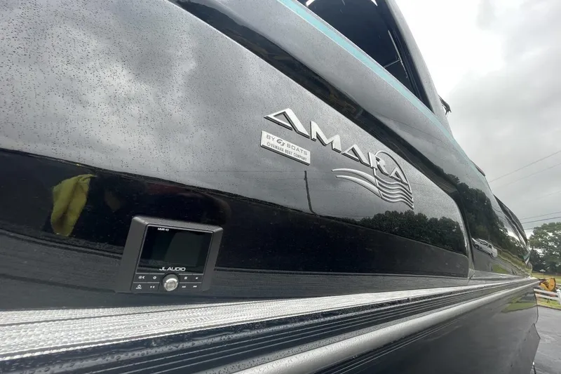 Slide: The Image of 2025 G 3 Amara boat with JL Audio system, sleek black exterior. - 8
