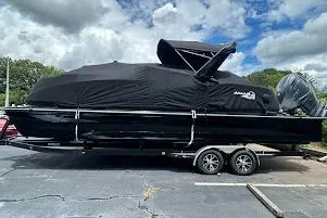 Slide: The Image of 2025 G3 AMARA boat covered on trailer, parked outdoors under cloudy sky. - 9