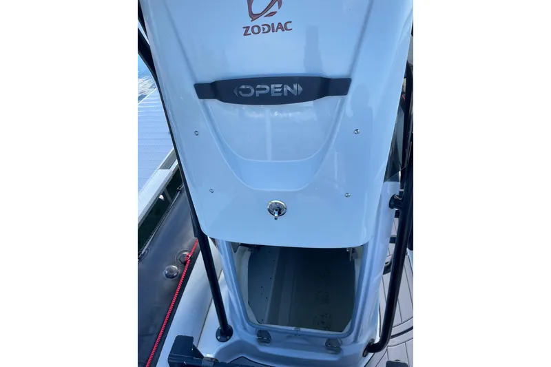 Slide: The Image of 2019 Zodiac Open 7 boat console with storage compartment open. - 11