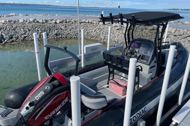 Slide: The Image of 2019 Zodiac Open 7 boat docked by the sea with Evinrude engine. - 16