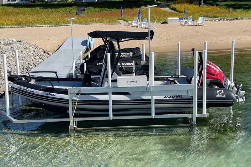 Slide: The Image of 2019 Zodiac Open 7 boat docked on clear water by a sandy beach. - 17