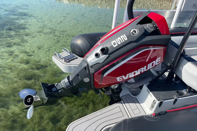 Slide: The Image of 2019 Zodiac Open 7 with Evinrude outboard motor on clear water. - 27
