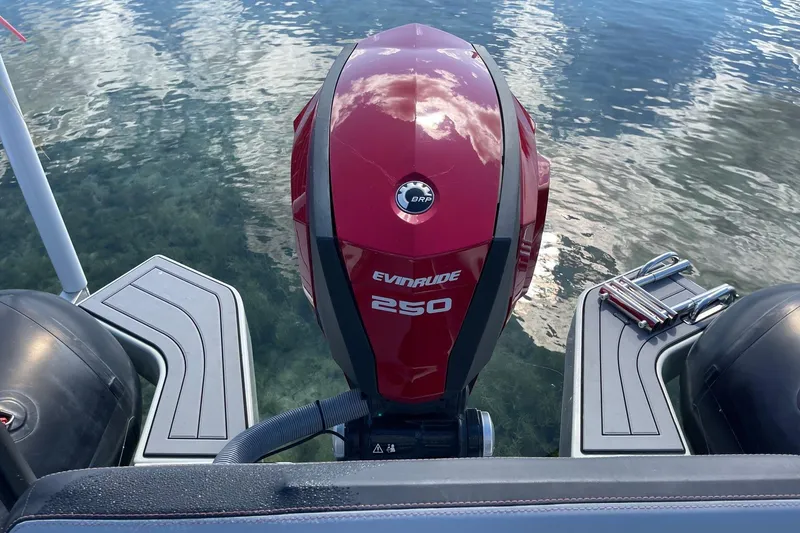Slide: The Image of Red Evinrude 250 outboard motor on 2019 Zodiac Open 7 boat, water reflection. - 29