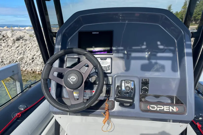 Slide: The Image of 2019 Zodiac Open 7 boat dashboard with steering wheel and control panel. - 3