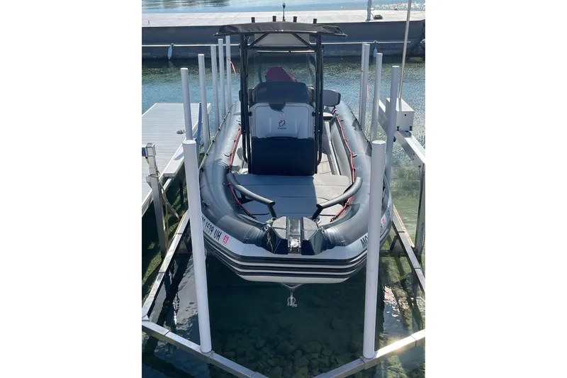 Slide: The Image of 2019 Zodiac Open 7 boat docked on a lift in clear water. - 6