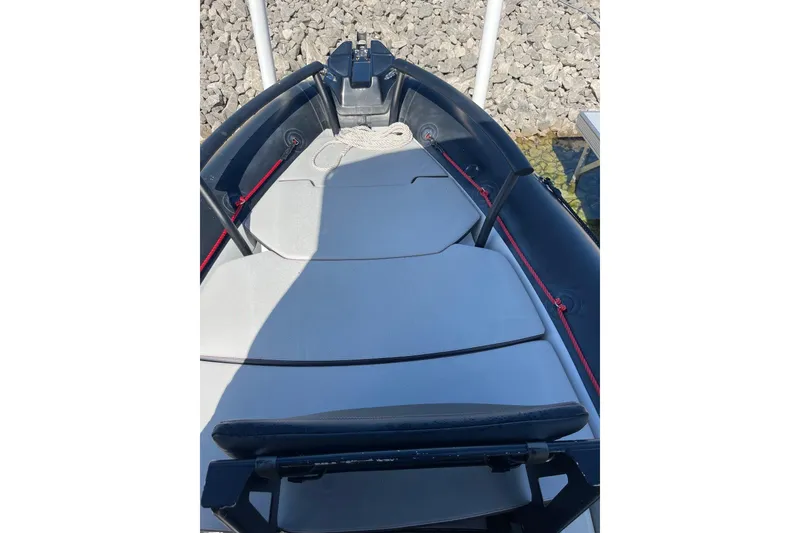Slide: The Image of 2019 Zodiac Open 7 boat interior with cushioned seating and red accents. - 8
