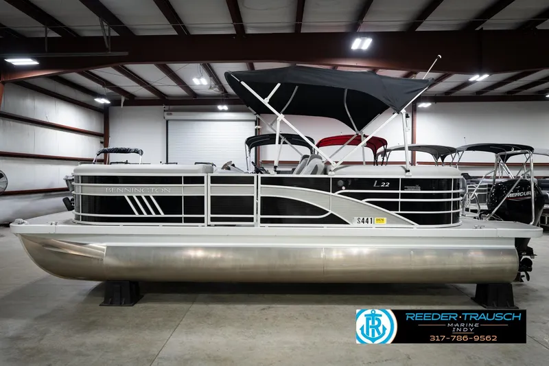 Slide: The Image of 2023 Bennington 22 LSR pontoon boat in a showroom with canopy and sleek design. - 10