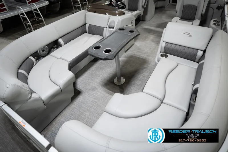 Slide: The Image of 2023 Bennington 22 LSR pontoon boat interior with plush seating and table. - 11