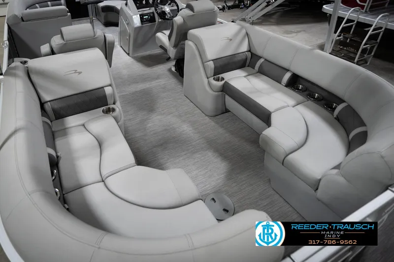 Slide: The Image of Luxurious interior of 2023 Bennington 22 LSR pontoon boat with plush seating and cup holders. - 14