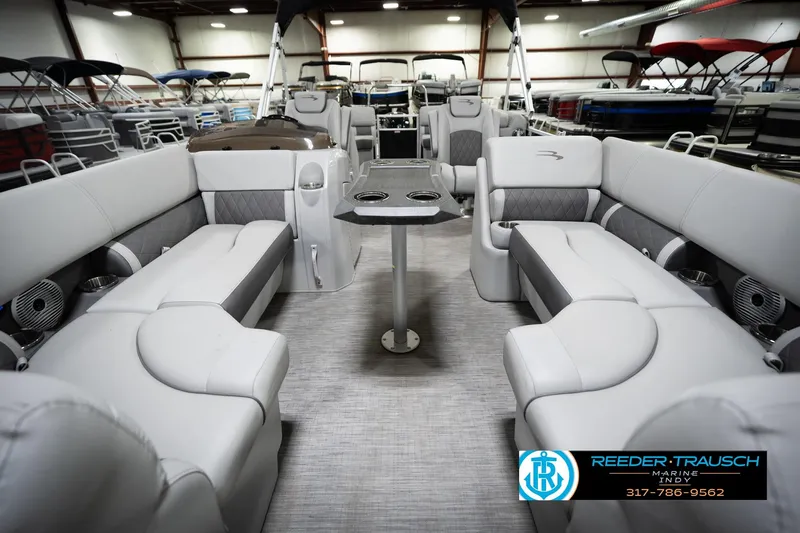 Slide: The Image of Interior of 2023 Bennington 22 LSR pontoon boat with luxurious seating and table. - 15