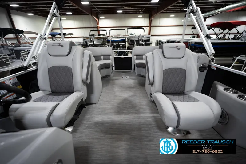 Slide: The Image of 2023 Bennington 22 LSR pontoon boat interior with luxurious seating in a showroom. - 16