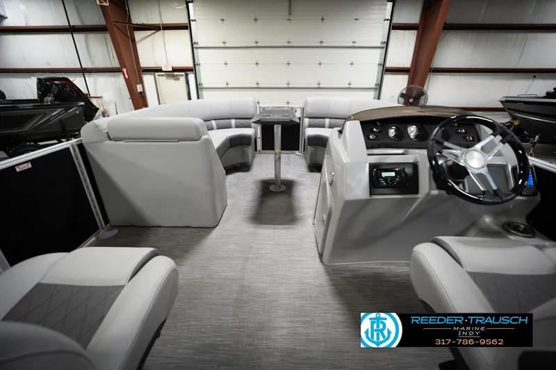 Slide: The Image of 2023 Bennington 22 LSR boat interior with plush seating and modern dashboard. - 19