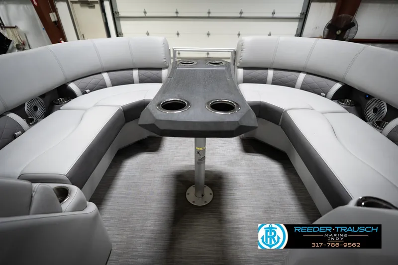 Slide: The Image of 2023 Bennington 22 LSR boat interior with gray seating and table, featuring cup holders. - 20