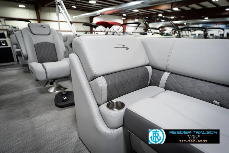 Slide: The Image of 2023 Bennington 22 LSR boat interior with luxurious gray seating and cup holder. - 23