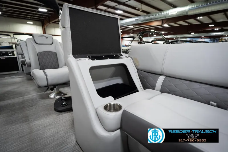 Slide: The Image of 2023 Bennington 22 LSR boat interior with open storage compartment and seating. - 24