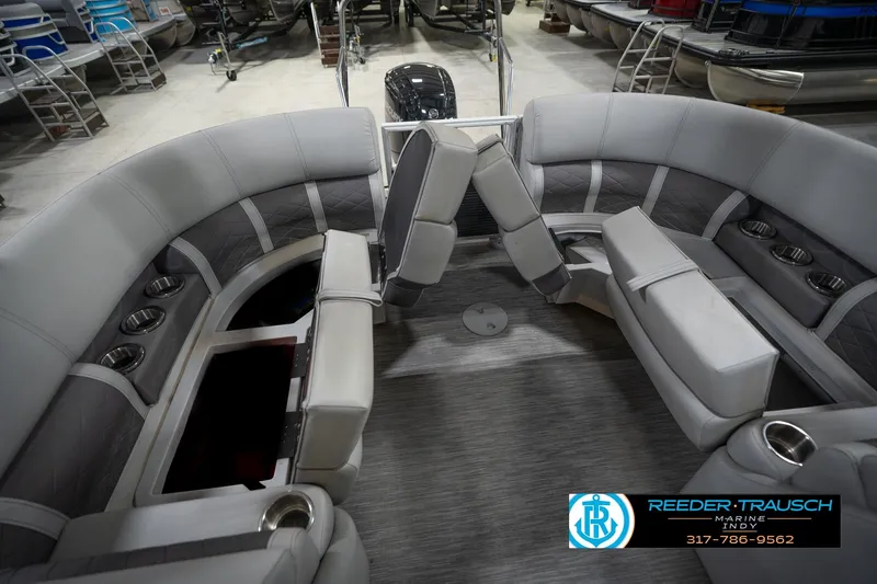 Slide: The Image of 2023 Bennington 22 LSR pontoon boat interior with gray seating and cup holders. - 26