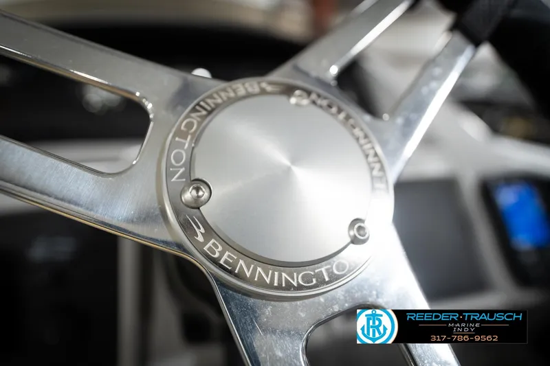 Slide: The Image of Close-up of 2023 Bennington 22 LSR steering wheel with Reeder-Trausch Marine logo. - 31