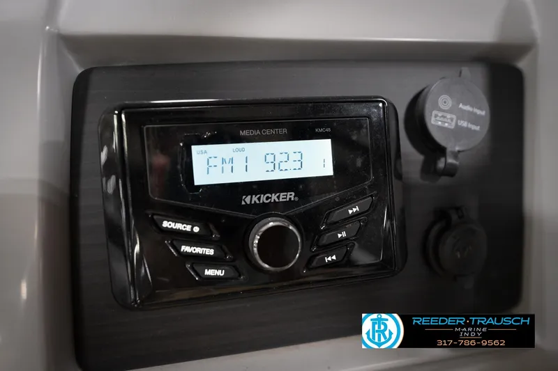 Slide: The Image of Kicker media center in 2023 Bennington 22 LSR boat, displaying FM 92.3. - 32
