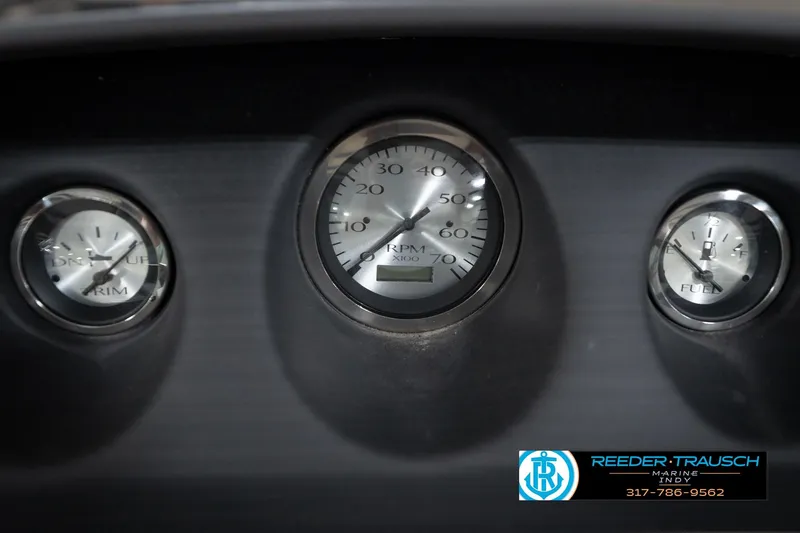 Slide: The Image of Dashboard gauges of a 2023 Bennington 22 LSR boat, featuring RPM, trim, and fuel indicators. - 34