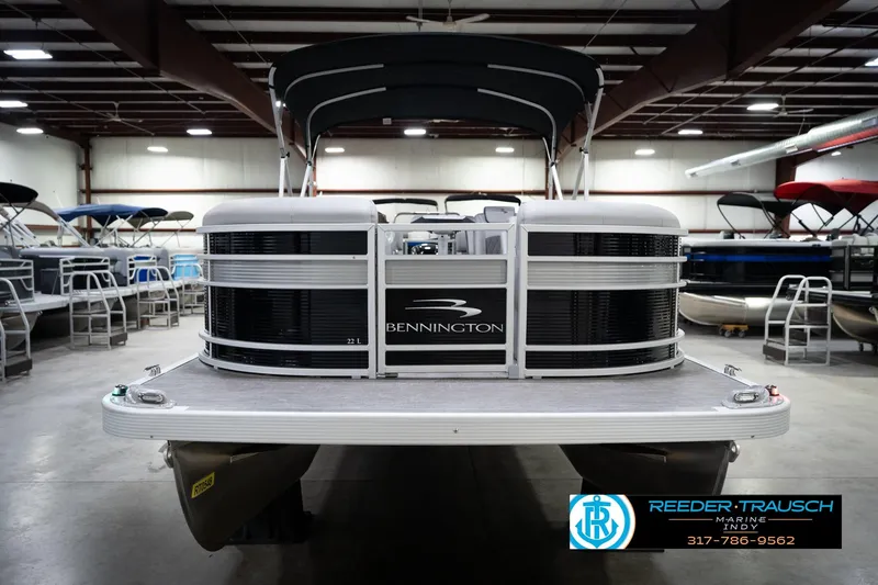 Slide: The Image of 2023 Bennington 22 LSR pontoon boat in showroom, front view with canopy. - 4