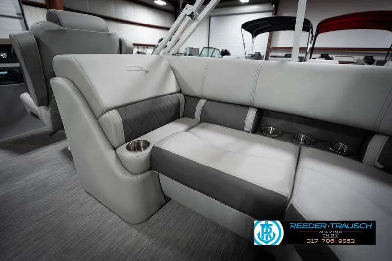 Slide: The Image of Luxurious seating in 2023 Bennington 22 LSR boat with cup holders, showcased indoors. - 40
