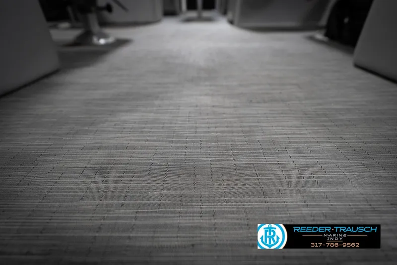 Slide: The Image of 2023 Bennington 22 LSR boat interior flooring, featuring textured design and Reeder-Trausch Marine logo. - 45