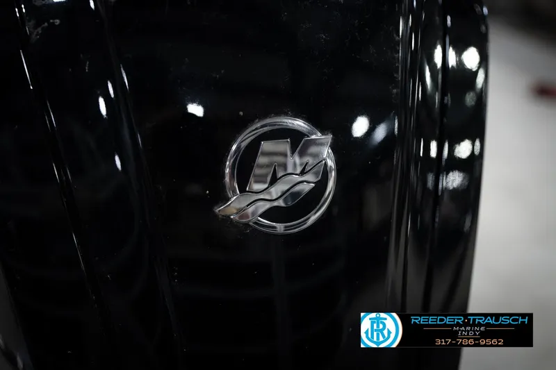 Slide: The Image of Close-up of a 2023 Bennington 22 LSR boat emblem with dealership logo. - 49