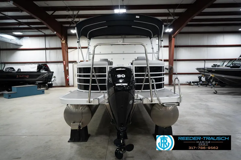 Slide: The Image of 2023 Bennington 22 LSR pontoon boat in showroom with Mercury 90 engine. - 8