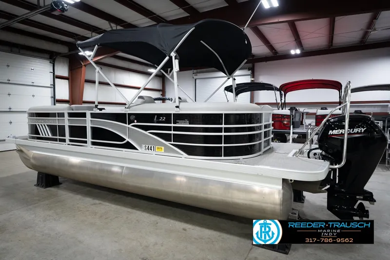 Slide: The Image of 2023 Bennington 22 LSR pontoon boat with Mercury engine in a showroom. - 9