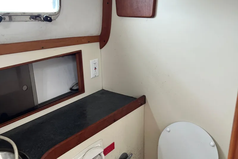 Slide: The Image of 2005 Legacy Yachts 28 interior with countertop and window, showcasing compact design. - 15