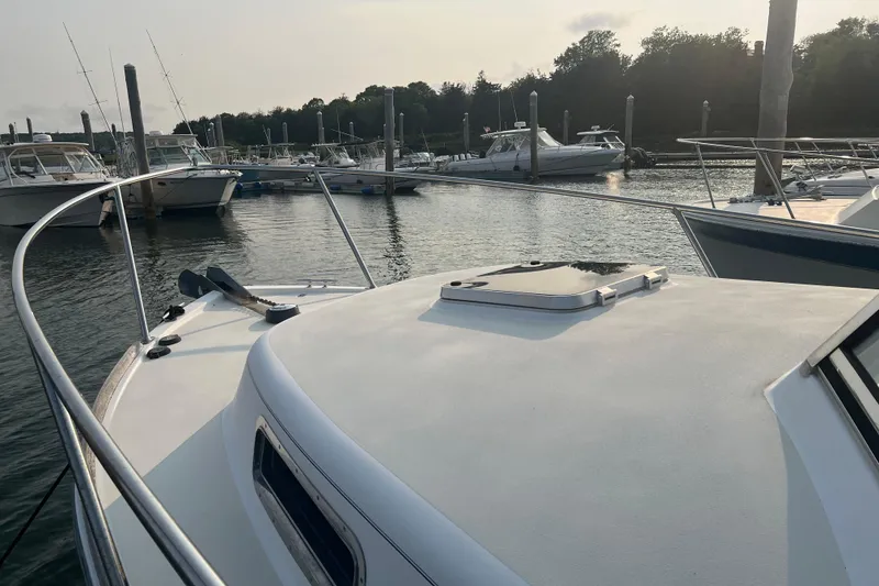 Slide: The Image of 2005 Legacy Yachts 28 docked in a serene marina setting. - 3