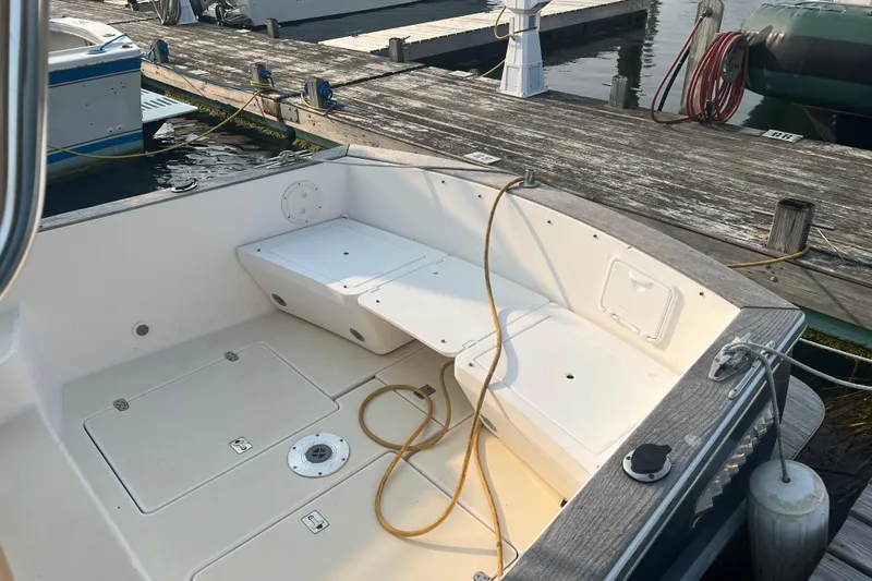 Slide: The Image of 2005 Legacy Yachts 28 docked, showcasing spacious deck and seating area. - 4