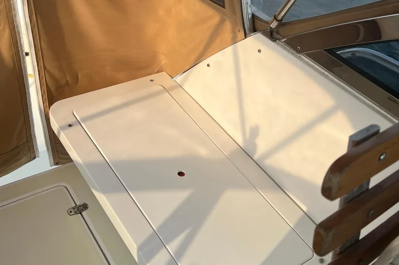 Slide: The Image of 2005 Legacy Yachts 28 interior detail with beige canopy and wooden accents. - 5