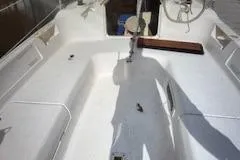 Slide: The Image of 1996 Hunter 23.5 sailboat cockpit with steering wheel and seating area. - 3