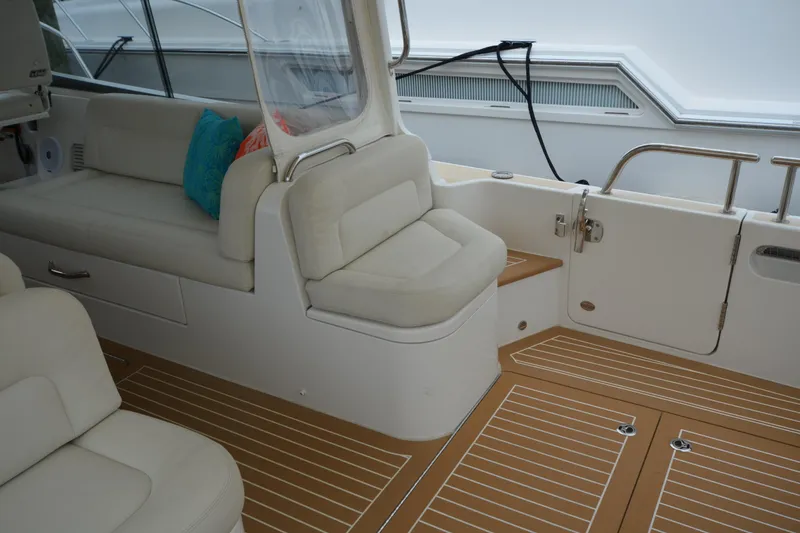 Slide: The Image of Interior of 2020 MJM 43z boat with cushioned seating and teak flooring. - 13