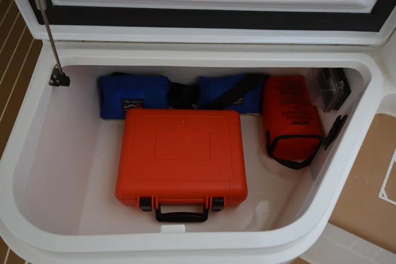 Slide: The Image of Storage compartment on 2020 MJM 43z boat with safety equipment and orange case. - 15